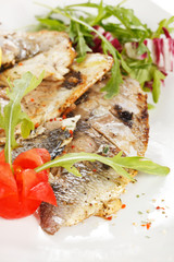 Grilled fish fillet with tomato and lemon