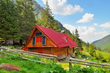 Wooden mountain rescue chalet with solar panels