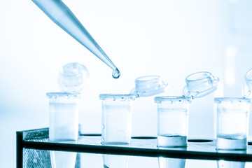 pipette and test tube on blue background