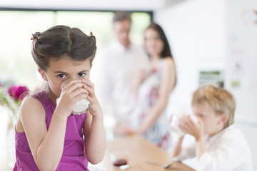 family in the kitchen at breakfast a little girl at foreground