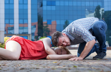 Man checking if woman's breathing