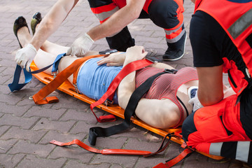 Paramedics taking woman to the hospital