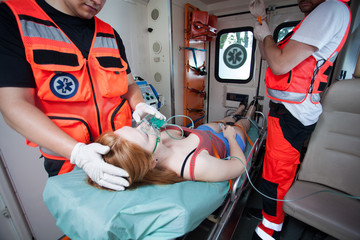 Unconscious woman and working paramedics