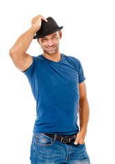 Smiling young man holding a  hat