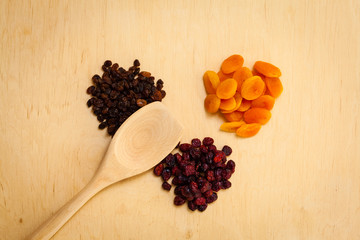 Dried fruits raisins apricots cranberries on table