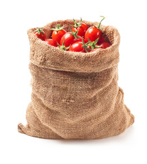 Tomatoes in canvas bag isolated on white background