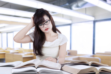 Confused student reading many books 3