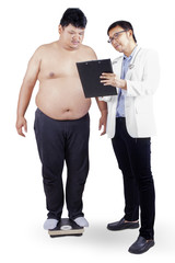 Doctor showing report to fat man