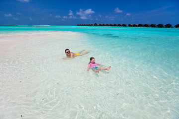 Mother and daughter at tropical beach
