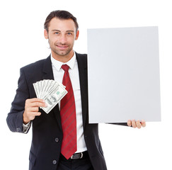 Smiling young business man holding a placard