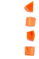 Bite sized papaya fruit over white background