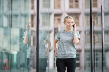 Fototapeta premium Young business woman speaking on the phone