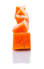 Bite sized papaya fruit over white background