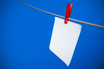 Paper card and peg hanging on the rope