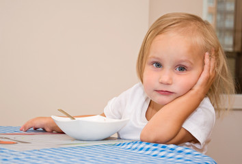 child eats in the kitchen