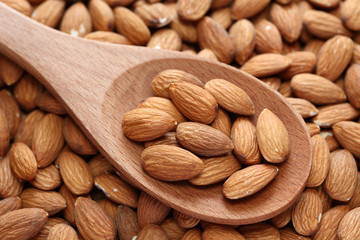 Almonds on a wooden spoon