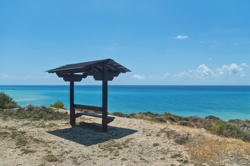 bench with roof facing sea