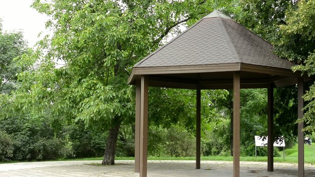 outdoor gazebo in the park - green trees