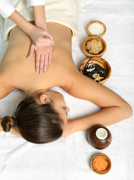 portrait of young beautiful woman in spa environment gets massag