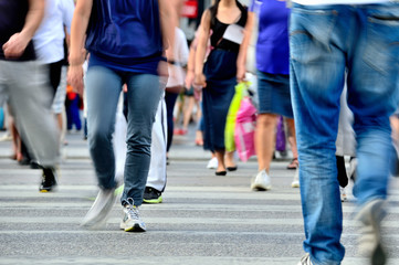 Motion blurred pedestrians crossing street