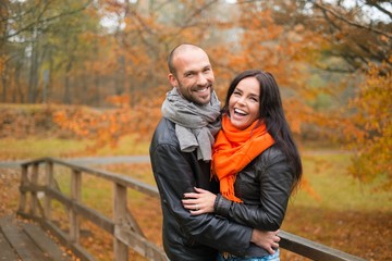 Naklejka na ściany i meble Happy middle-aged couple outdoors on an autumn day