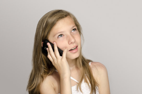 Young girl talking on the phone, teenager using a cellphone