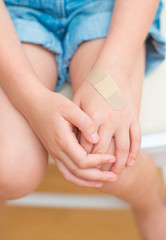Child hand with an adhesive bandage.