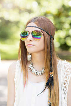 Portrait of beautiful young woman with sunglasses hippie style,