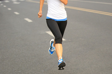 Fototapeta na wymiar Runner athlete running on city road