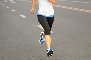 Fototapeta premium Runner athlete running on city road
