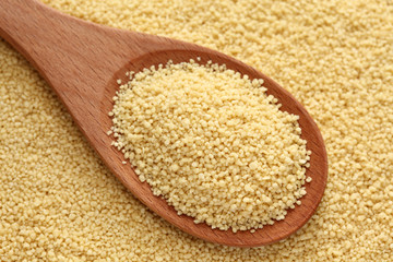 Couscous in a wooden spoon