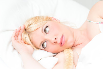 Fototapeta na wymiar Beautiful blonde woman in the bed