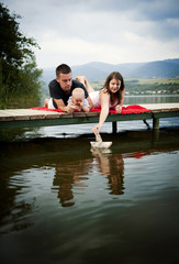 Obraz premium Family with baby on pier