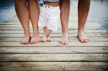Family feet on pier