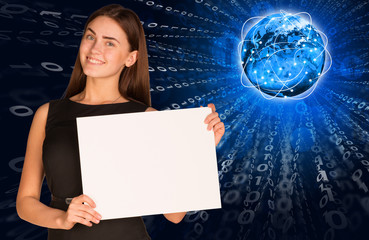 Businesswoman with glowing figures and Earth