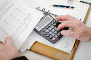 Businessman calculating financial results