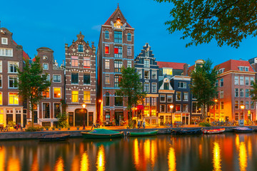 Night city view of Amsterdam canal with dutch houses
