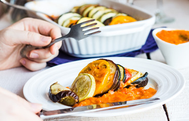 processes food vegetable ratatouille with a fork and knife, hand