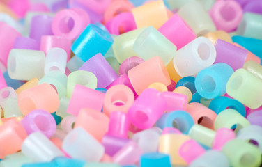 Fototapeta na wymiar Close Up of pixel beads, plastic granules or plastic beads
