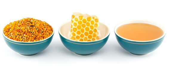 Honey, honeycomb and pollen in bowls