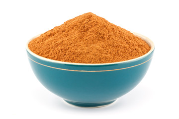 Ground cinnamon in bowl