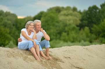 Fototapeta na wymiar Amusing elderly couple on the beach