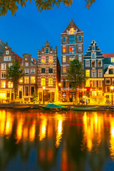 Fototapeta na wymiar Night city view of Amsterdam canal with dutch houses