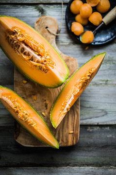 Sliced melon on wooden background