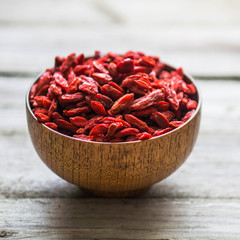 Goji berries on wooden background