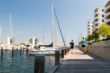 Two men running at the waterfront