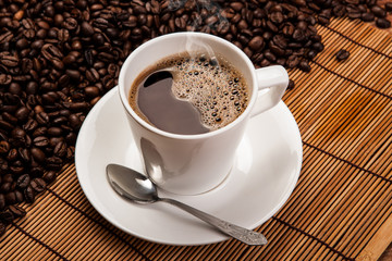 cup of black coffee with roasted coffe beans