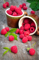 Red ripe raspberries on a wooden background