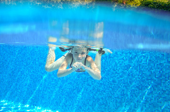 Child swims in swimming pool, underwater and above view