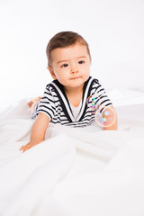Fototapeta premium isolated studio portrait of lovely toddler baby boy playing